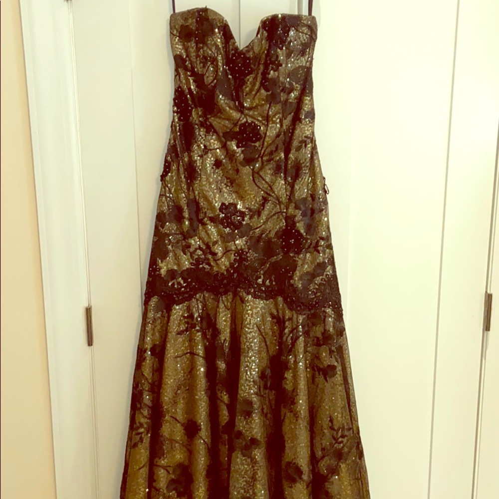 Strapless black and gold ball gown with train.